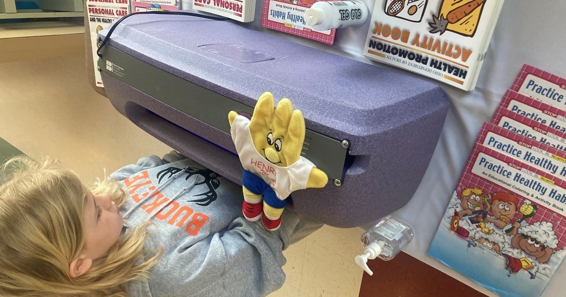 Buckeye student using the Handwashing Germ light.